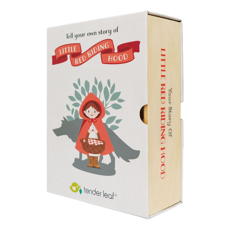 A boxed product titled 'Tell your own story of Little Red Riding Hood' by tender leaf, shown at a three-quarter angle on a white background. The box is off-white with a red ribbon banner, an illustration of Little Red Riding Hood in a red hood holding a basket, gray wolf silhouette, and green leaves.