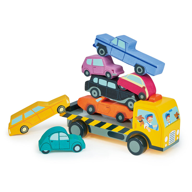 A set of colorful wooden toy cars stacked on top of each other on a wheeled recovery truck.