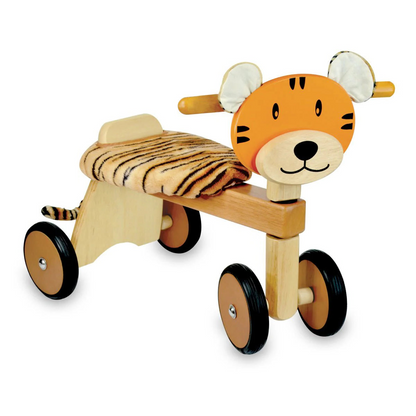Paddle Rider Tiger wooden trike toy. Ride-on toy with cute orange and black painted tiger face, fabric ears, padded tiger stripe seat, wooden frame and wheels with black rubber trims.