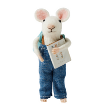 Handmade wool felt mouse in blue denim overalls holding a book, standing upright on a white background.