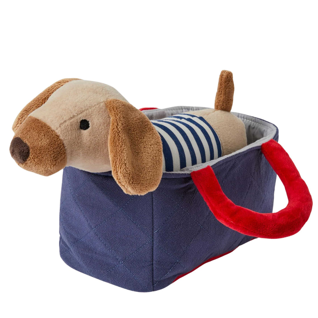 Brown puppy soft toy in blue carry basket with red handles. jiggle and Giggle soft toys at Send A Toy