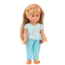 A 27cm vinyl doll with long blonde hair, wearing a white singlet, turquoise lace top, and orange satin shoes, standing against a plain background.