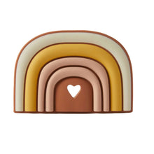 A silicone teether designed in a rainbow arch shape with a heart cut-out at the center, featuring multiple colors including blue, green, yellow, and brown.
