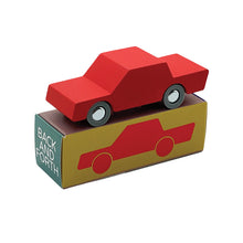 A red wooden toy car labeled 'BACK & FORTH' on a packaging box.