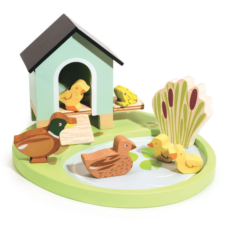 Wooden toy set with ducks and a duckhouse on a white background