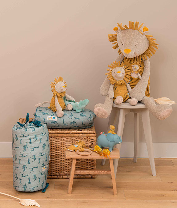 Children's room with plush lion toys and storage bins on a wooden floor.