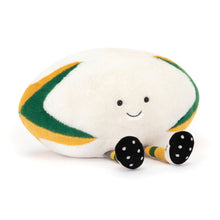 Plush toy shaped like a rugby ball with a smiling face on a white background