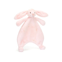 A plush pink bunny comforter with long lop ears, a pink suedette nose, and embroidered eyes. It has a soft, furry texture and is designed for young children.