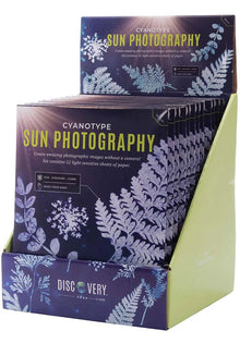Packaging for 'Cyanotype Sun Photography' kit by Discovery Zone, featuring images of plant leaves and a solar flare, indicating the use of sunlight for printing.