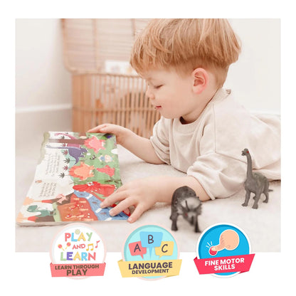 Child playing with a educational toy and book, surrounded by dinosaur figures.