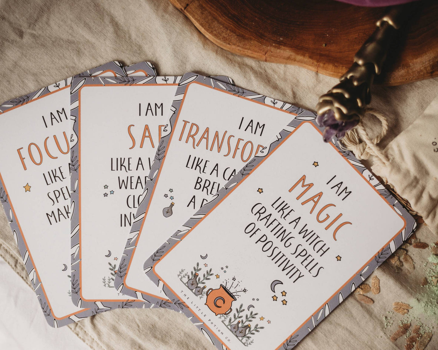 Set of affirmation cards with motivational phrases on a textured surface.