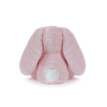 Pink plush bunny tail on a white background