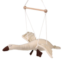 A beige fabric goose-shaped mobile with a wooden frame and white ropes for hanging.