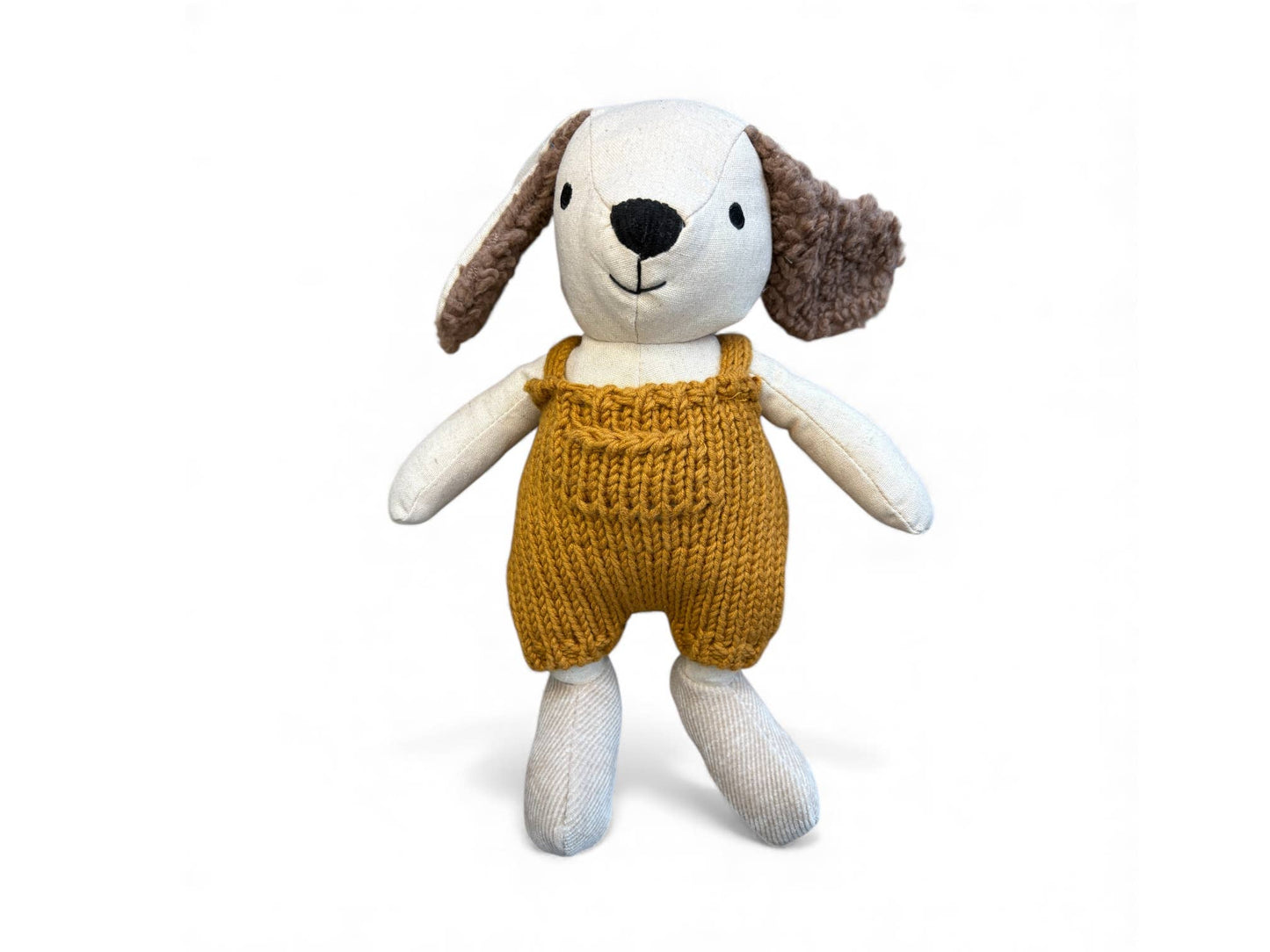 Stuffed toy dog wearing a mustard yellow knitted romper on a white background