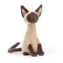 A plush toy resembling a Siamese cat with a beige body, brown ears, paws, and tail, and blue eyes.
