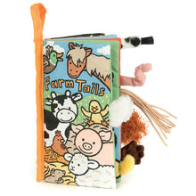 A colorful cloth book for babies and toddlers titled 'Farm Tails'. It features illustrations of farm animals like a cow, pig, and chicken, along with tactile elements like a sheep's tail.