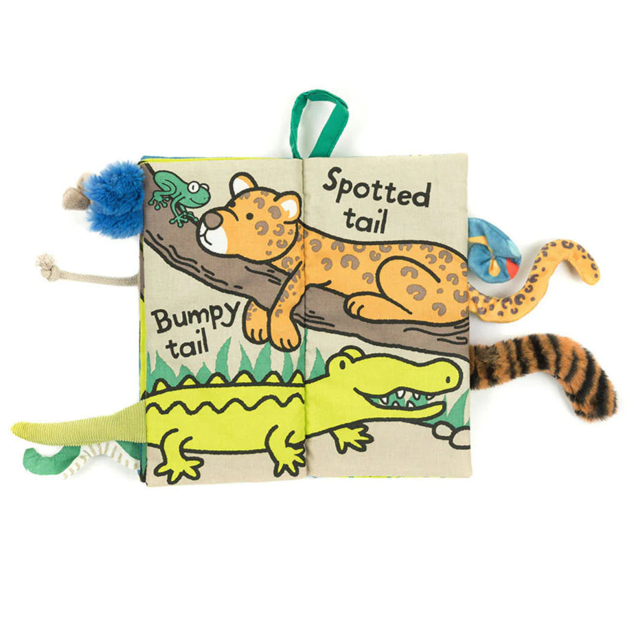 padded fabric book with jungle animal illustrations and 3D animal tails poking out.