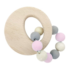 A round wooden rattle with a variety of beads in different colors attached to a ring for clutching and grasping.