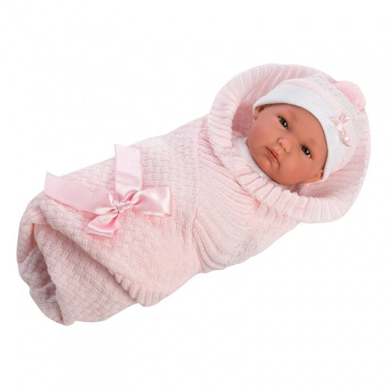 Loren’s brand baby doll toy swaddled in pink knitted blanket