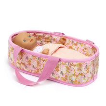 Doll in a floral baby carrier with pink trim on a white background