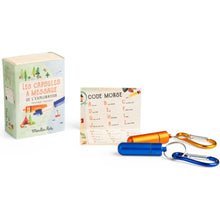 Message capsule set with code book and keychain on a white background