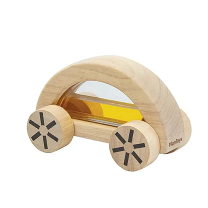 Natural wood car shape toy filled with yellow water behind clear plastic windows.