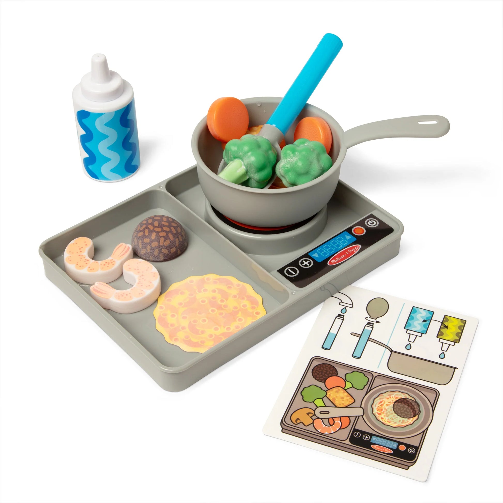 Toy kitchen set with cooking pan, tray, and toy food items on a white background