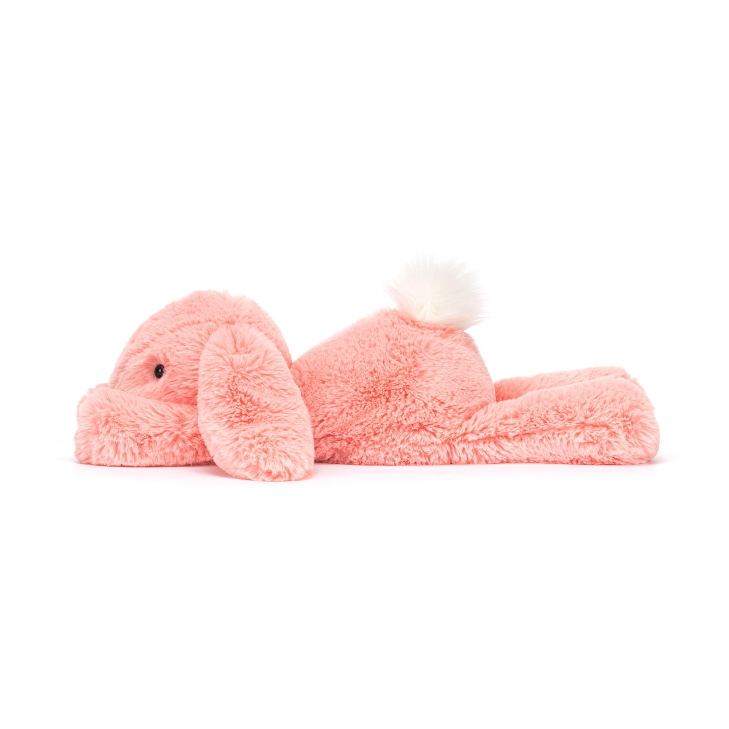 A plush toy resembling a lop-eared bunny in bright apricot fur with a fluffy cream bobtail.
