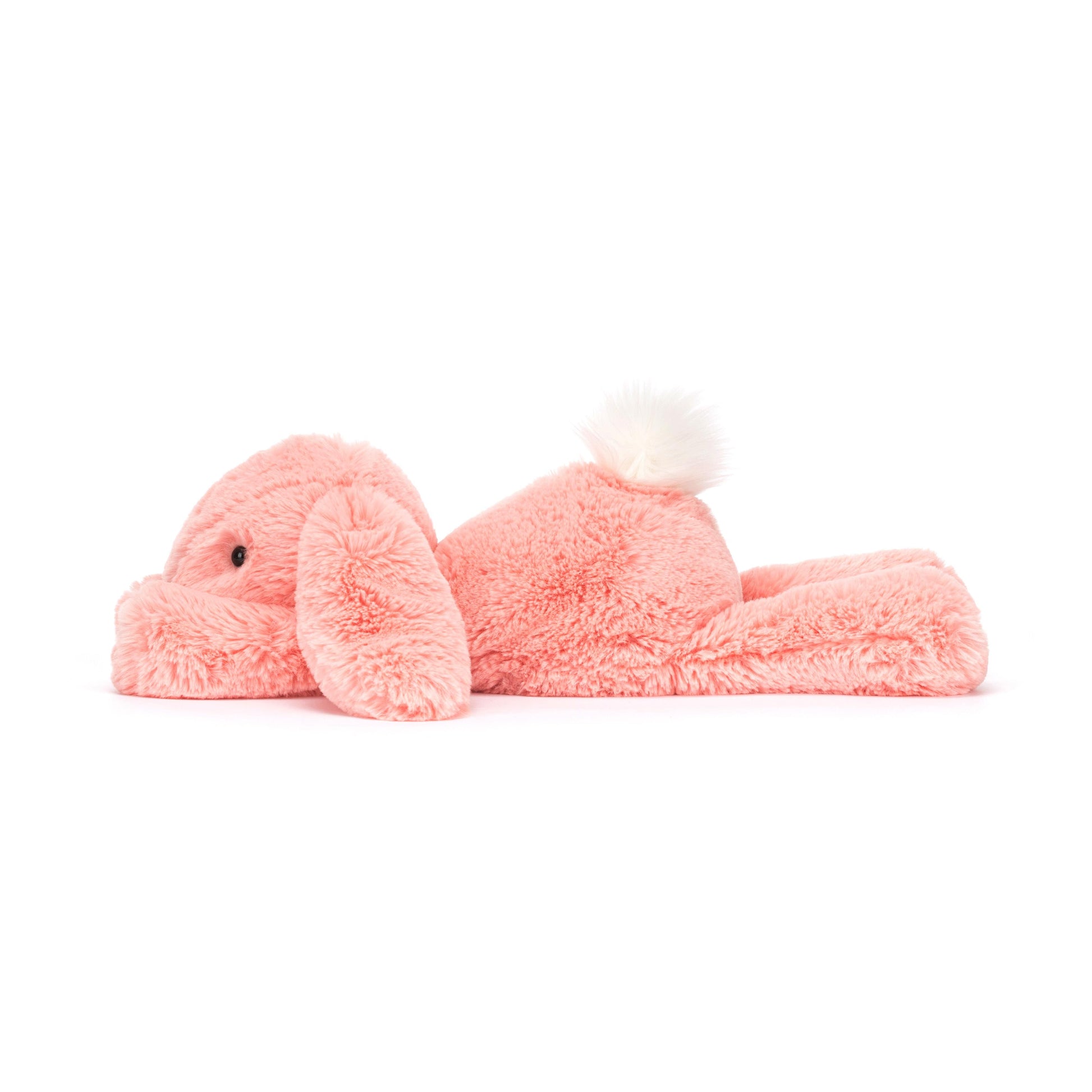A plush toy resembling a lop-eared bunny in bright apricot fur with a fluffy cream bobtail.
