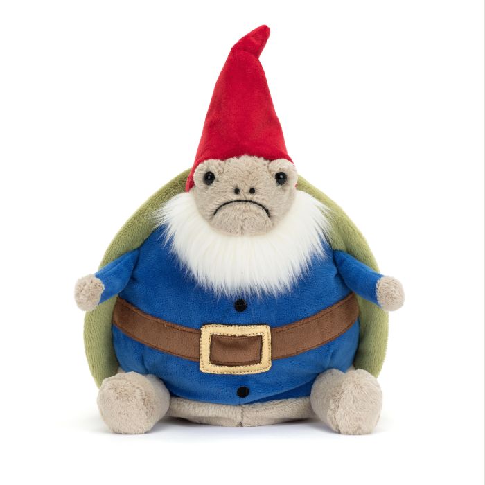 A plush toy depicting a garden gnome with a turtle shell, wearing a blue tunic, brown belt, green cape, and a red hat.