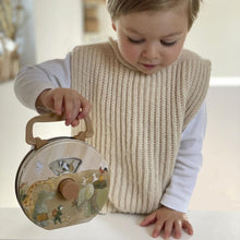 Child playing with Noah’s Animals tin radio toy