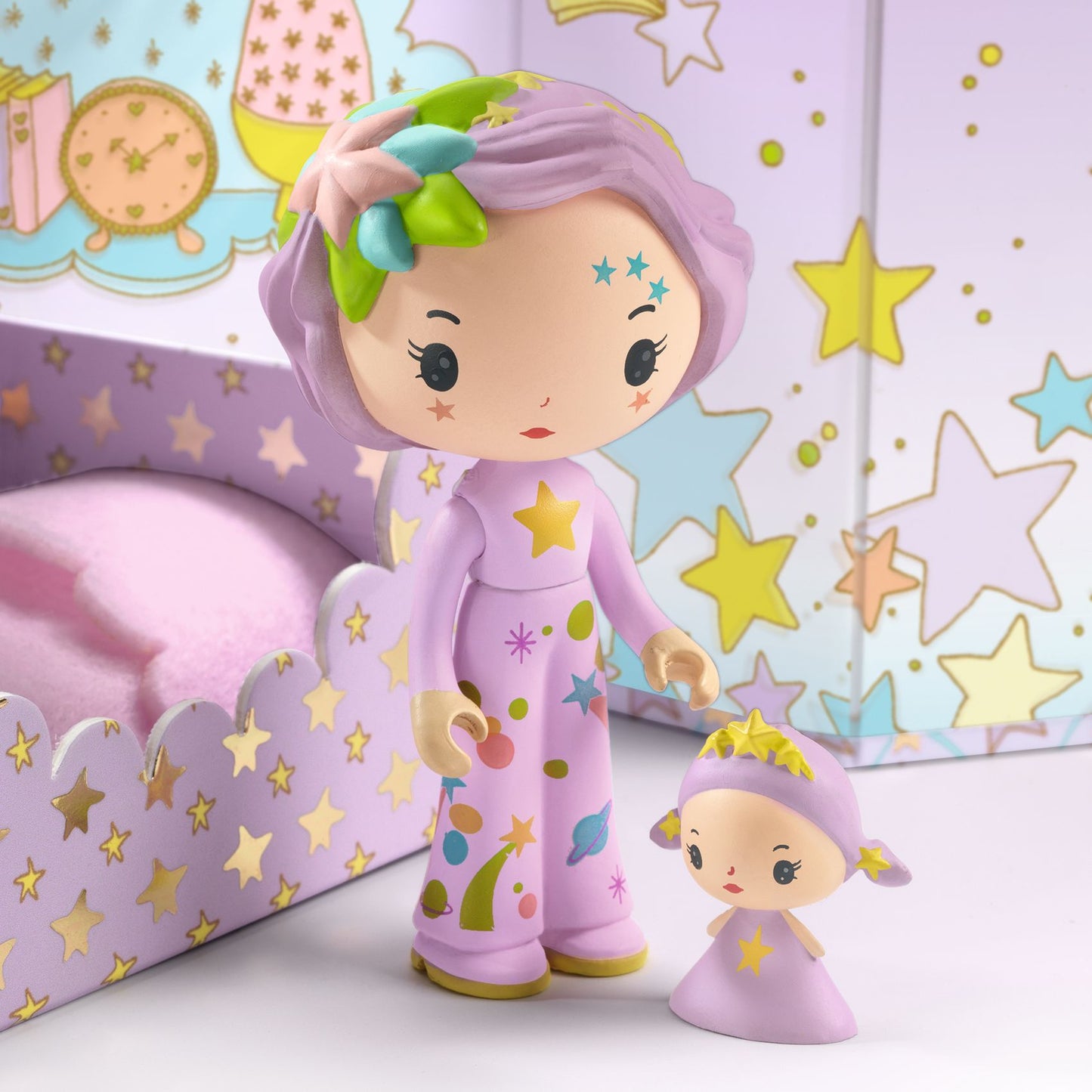 Two colorful dolls with star patterns against a star-patterned background