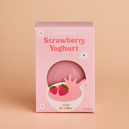 Pink packaging of doll pretend play strawberry yoghurt in a bowl and strawberries on a beige background