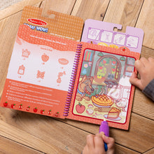 Coloring book with a child's hand holding a marker on a wooden surface