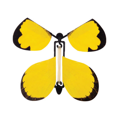 A wind-up butterfly with bright yellow wings and black edging, attached to a black body with a silver metal clasp, shown on a plain white background.