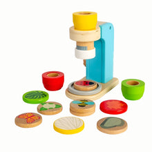 A wooden microscope toy with colorful lenses and play pieces, including magnification, kaleidoscope, and rose-tinted lenses, and wooden disks featuring bugs and plants.