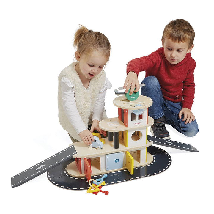 Children playing with Janod Garage playset - Send A Toy