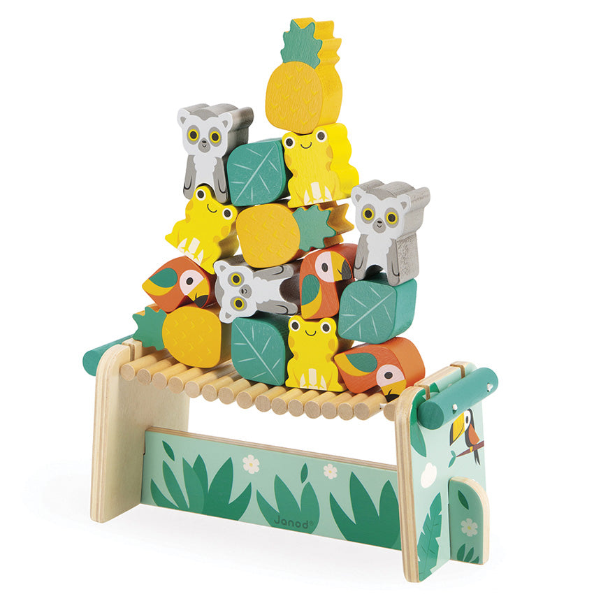 A wooden balancing game featuring colorful animal figures such as frogs, lemurs, and parrots on top of a bridge with leaf accents.