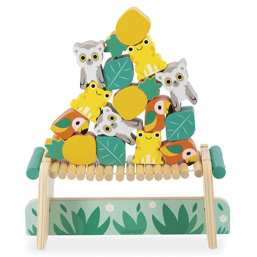 A wooden balancing game featuring colorful animal figures such as frogs, lemurs, and parrots on top of a bridge with leaf accents.