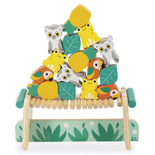 A wooden balancing game featuring colorful animal figures such as frogs, lemurs, and parrots on top of a bridge with leaf accents.