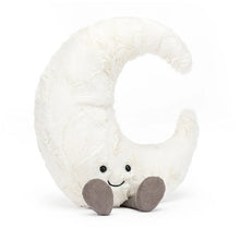 A plush toy resembling a crescent moon with a smiling face, velvety craters, and gray cord booties.