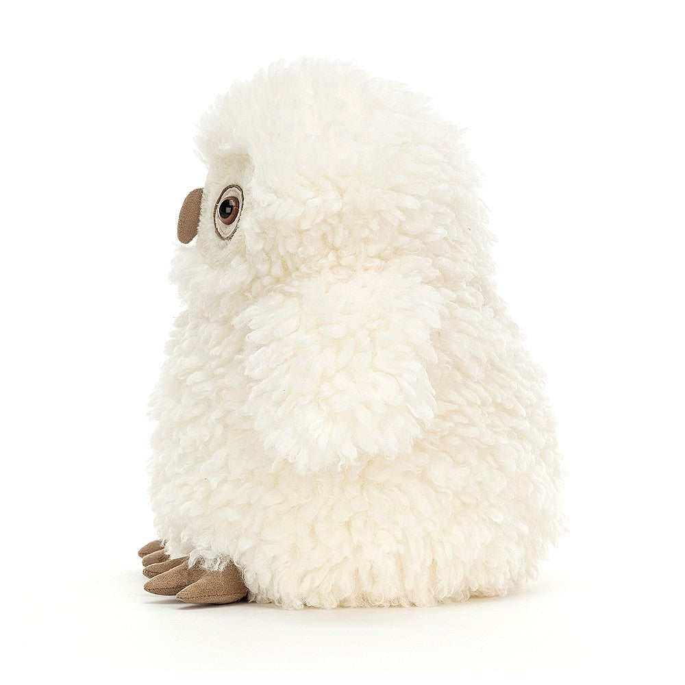 A plush toy resembling a white owl with fuzzy details, featuring bright eyes, a beak, and feet.