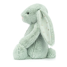 A medium-sized green plush toy rabbit with stars on its ears.