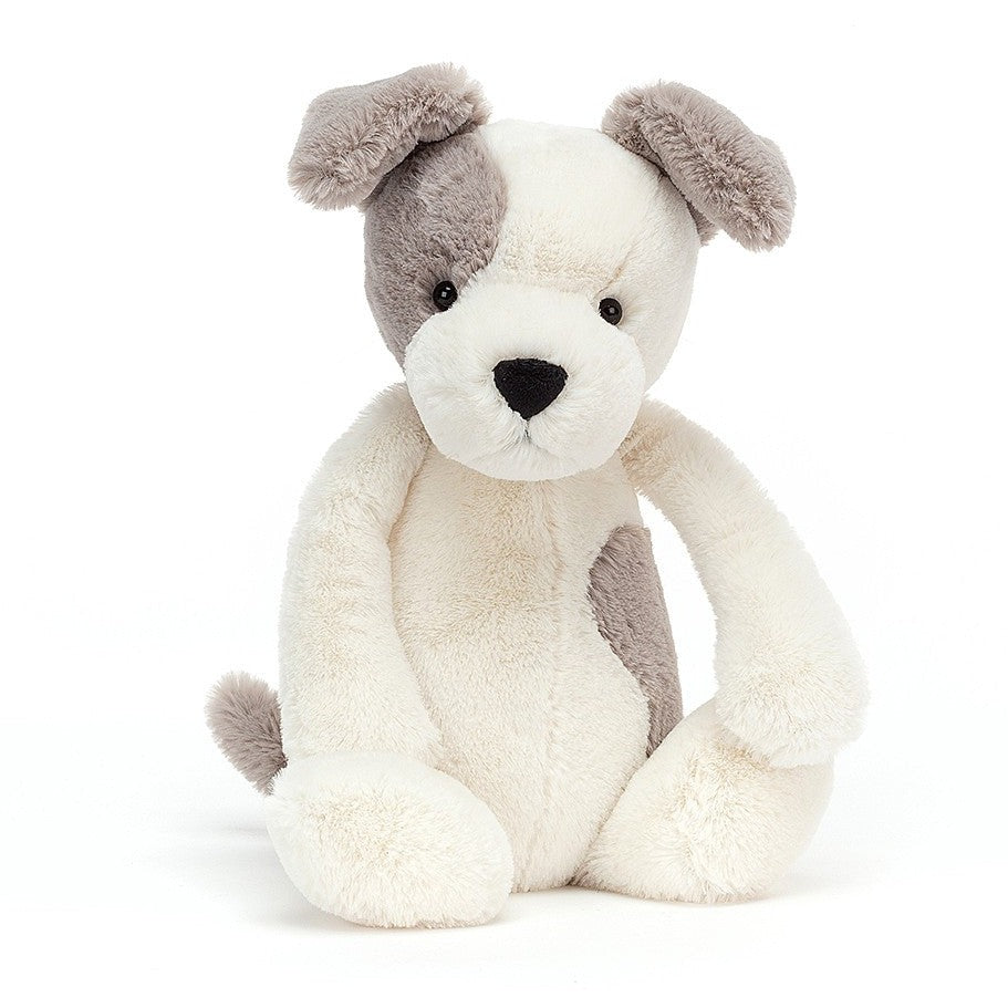 A plush toy resembling a terrier dog with a cream body, gray patches on the head and back, and a white face.