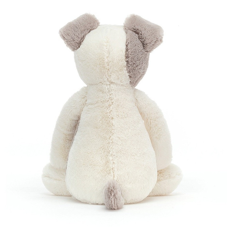 A plush toy resembling a terrier dog with a cream body, gray patches on the head .