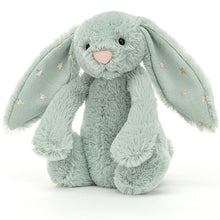 A medium-sized green plush toy rabbit with stars on its ears.