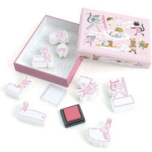 A set of decorative stamps with various designs, including animals and everyday items, displayed next to a pink box with a clear window showing the stamps inside.