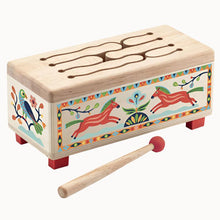 A wooden drum with colorful bird and horse illustrations, accompanied by a wooden drumstick. Designed for young children.