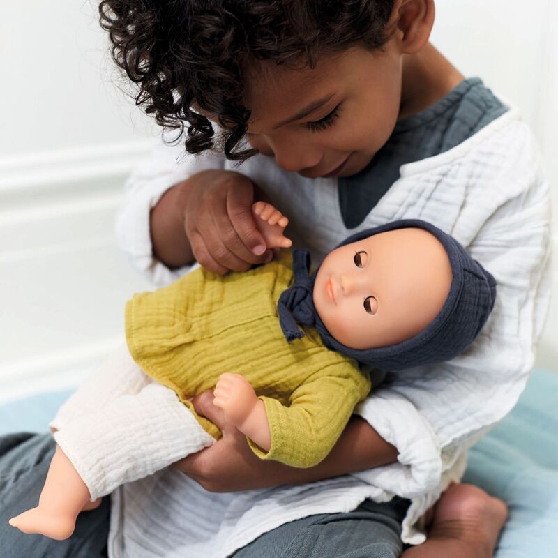 Child holding Baby Camomille Pomea Soft Body Doll