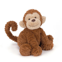 A plush toy resembling a smiling monkey with a brown color scheme, made of soft fabric.